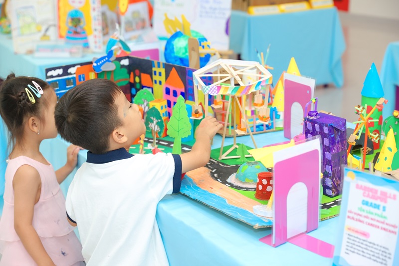 A child looking at a model of a cityDescription automatically generated